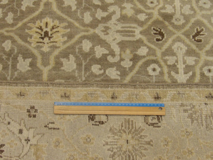 Brown and gold Oushak rug in room setting