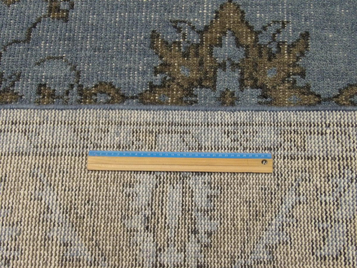 Black and blue Oushak rug in room setting