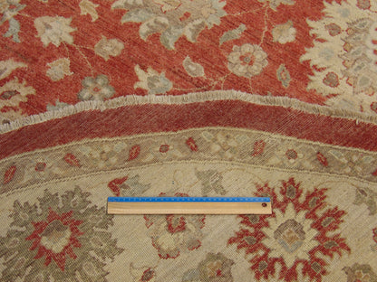 Beige and red Oushak round rug in room setting