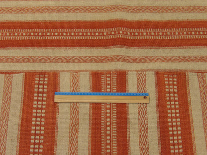 Beige and red coastal rug in room setting