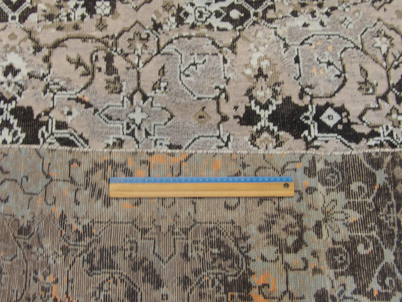 Transitional black and blue rug in room setting