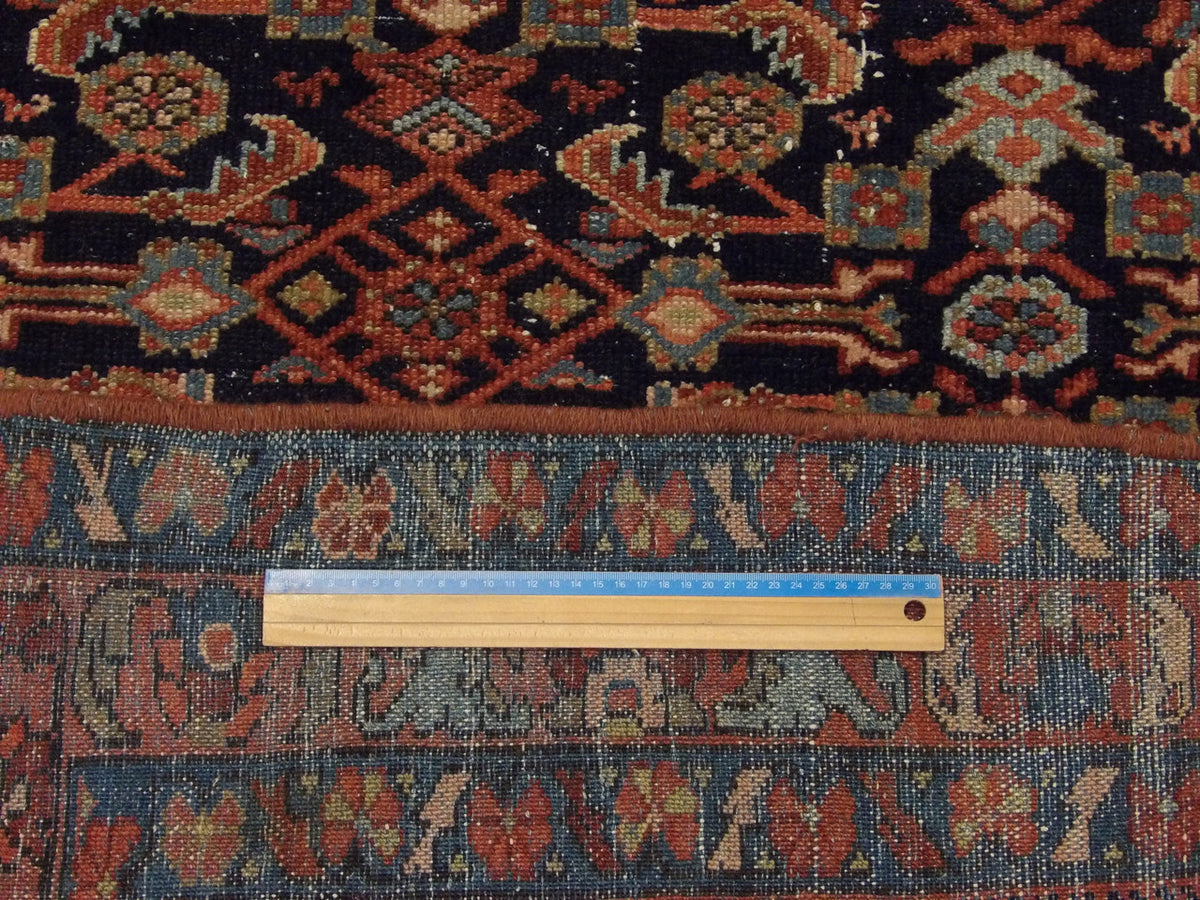 Blue and rust antique Mir rug in room setting