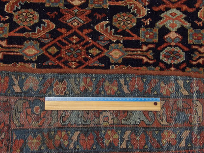 Blue and rust antique Mir rug in room setting