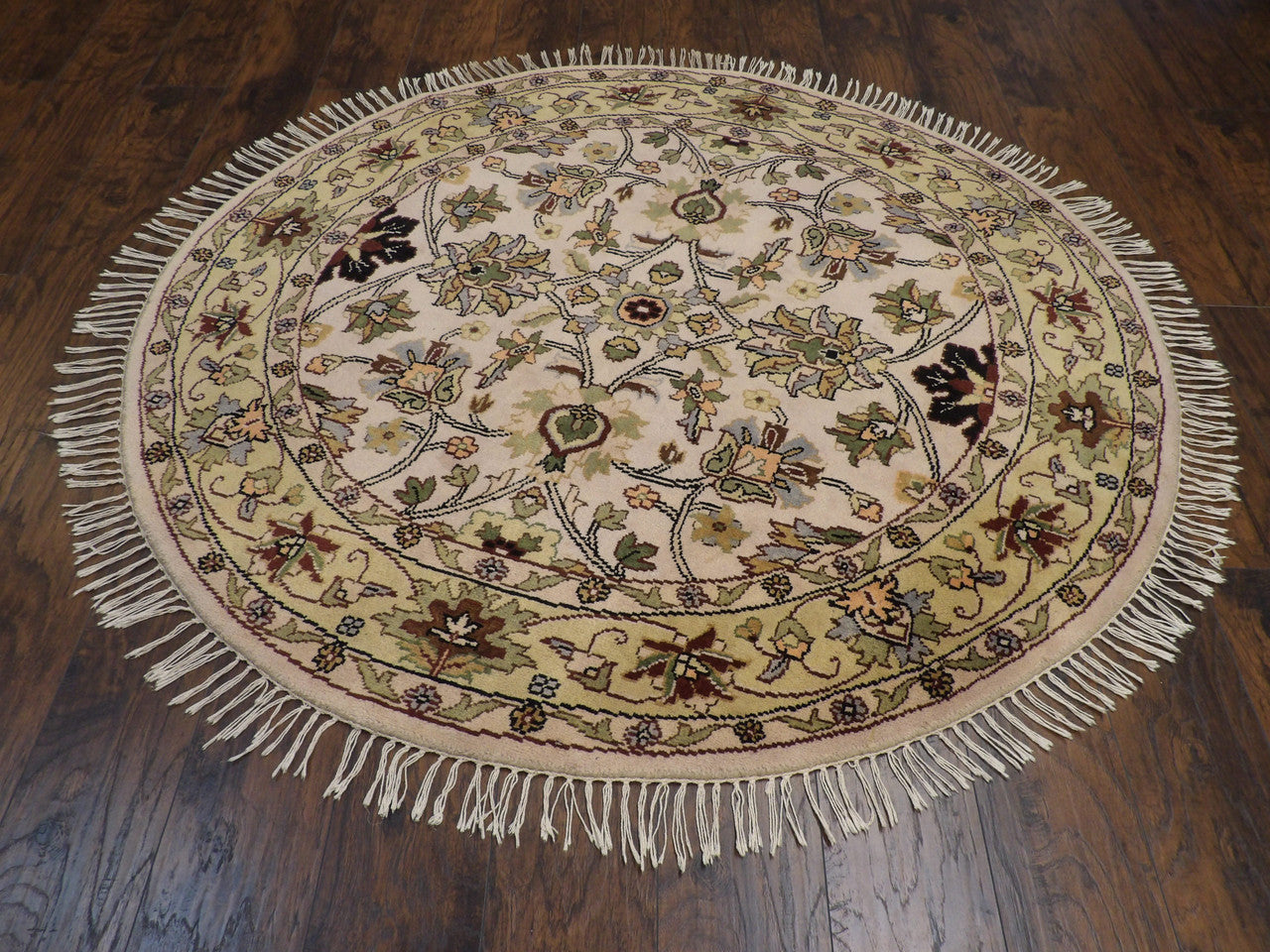 Close-up of wool pile, beige and gold round rug