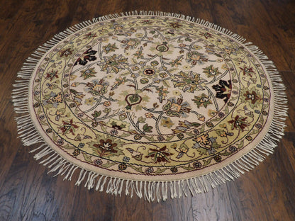 Close-up of wool pile, beige and gold round rug