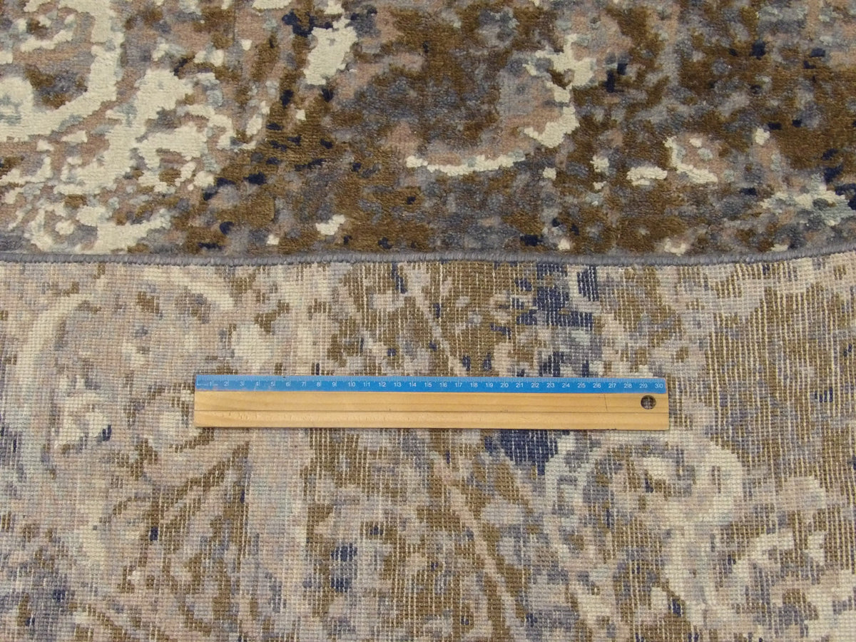 Blue and gray damask rug in room setting