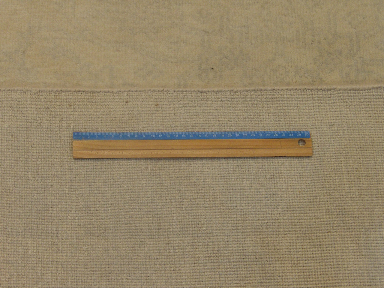 Beige Oushak rug in room setting