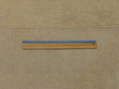 Beige Oushak rug in room setting
