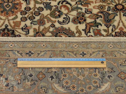Blue and ivory Kashan rug in room setting