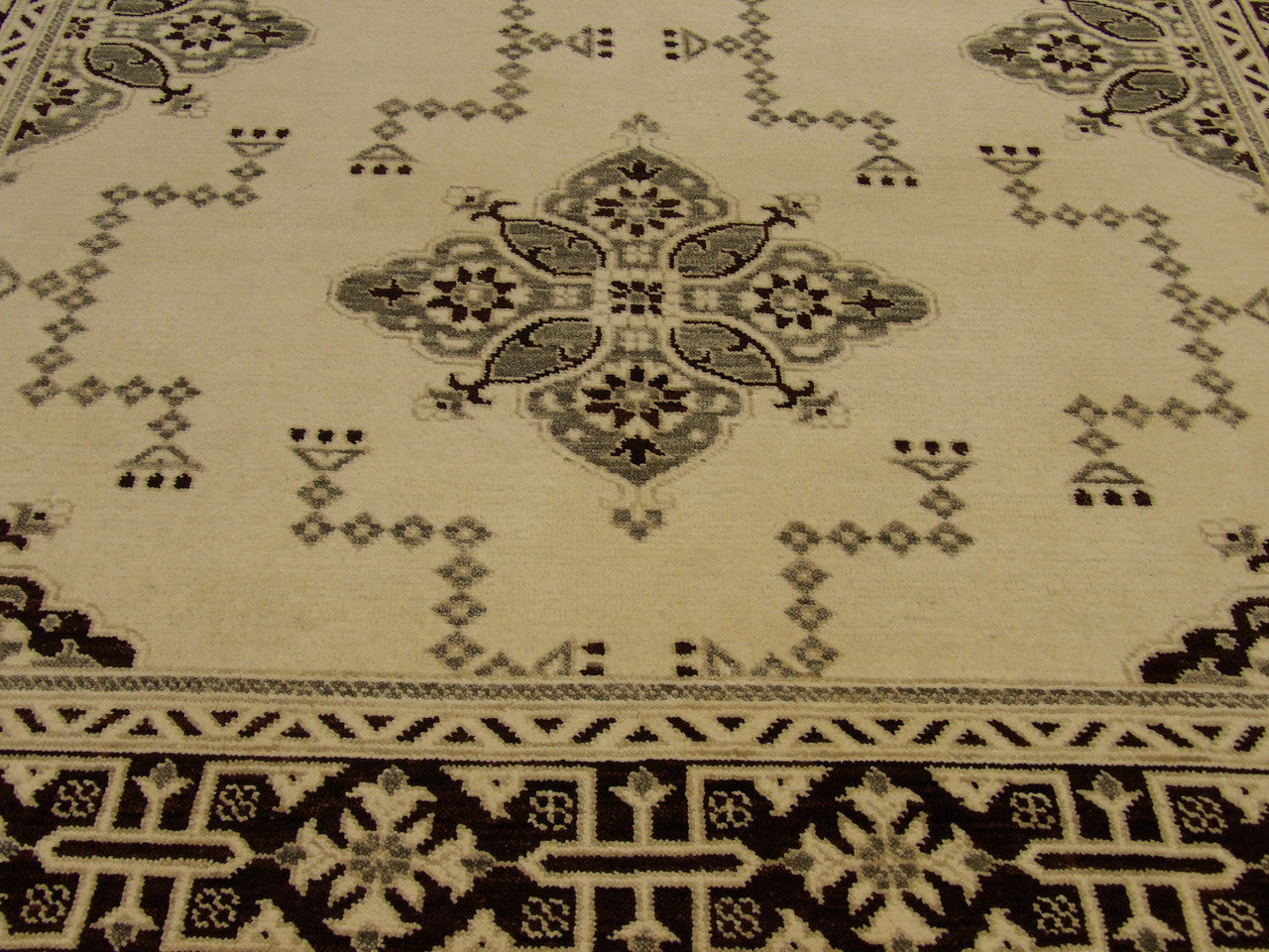 Oushak Kazak rug border detail, brown and ivory