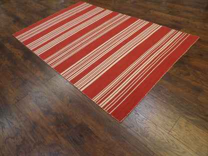 Beige and red coastal flatweave rug in a sunroom setting