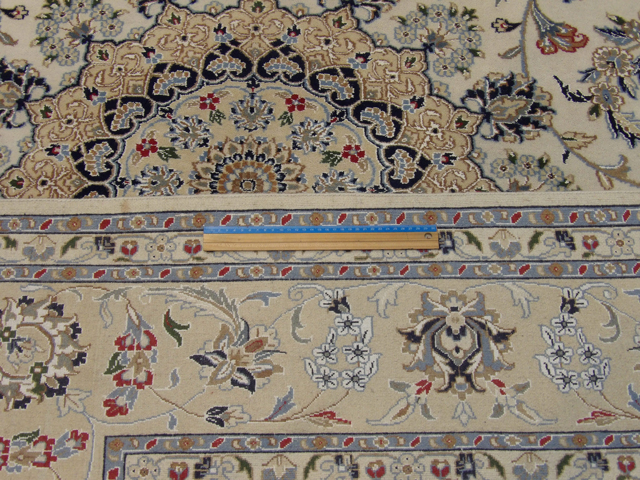 Beige Fine Persian Nain rug in room setting