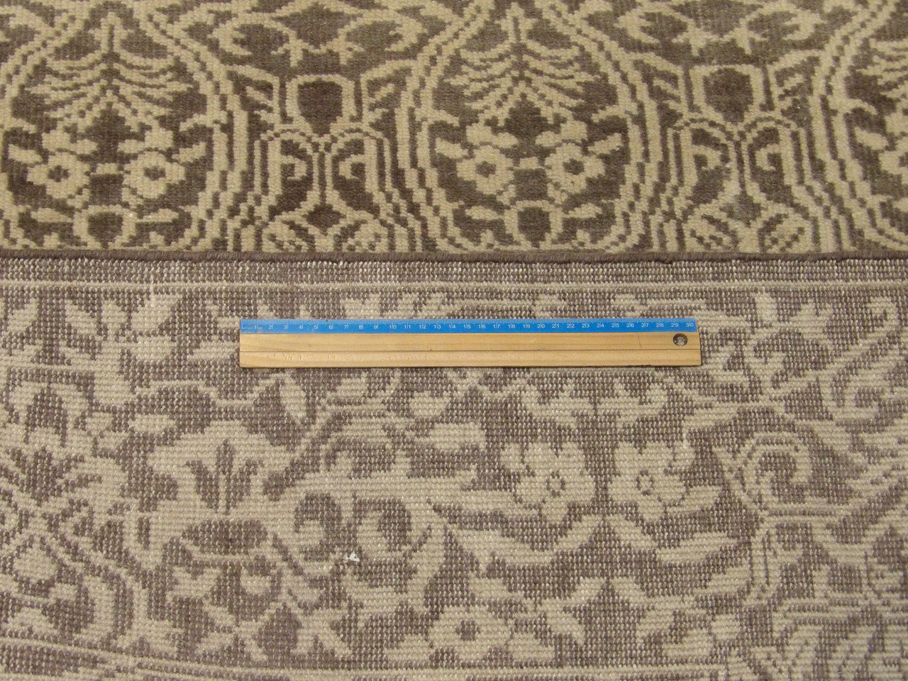 Full room view of damask hand-knotted wool rug in brown and gold
