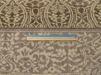 Full room view of damask hand-knotted wool rug in brown and gold