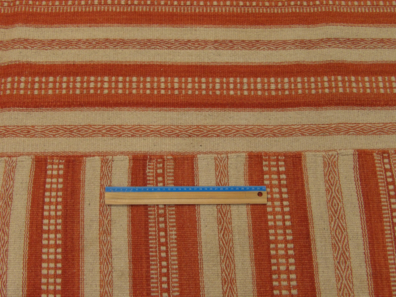 Ivory and rust coastal rug in room setting
