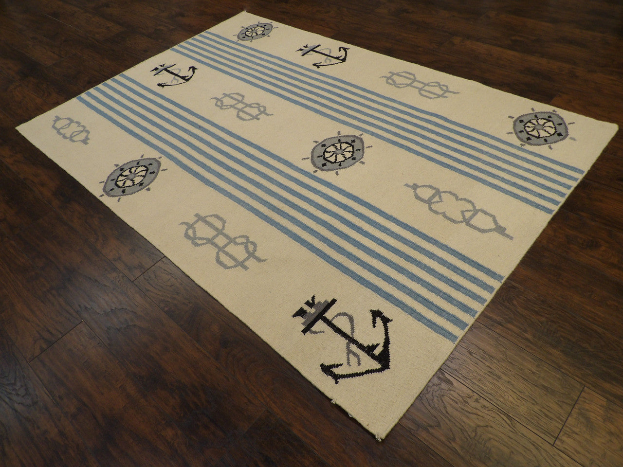 Blue and white coastal flatweave rug in a sunroom setting