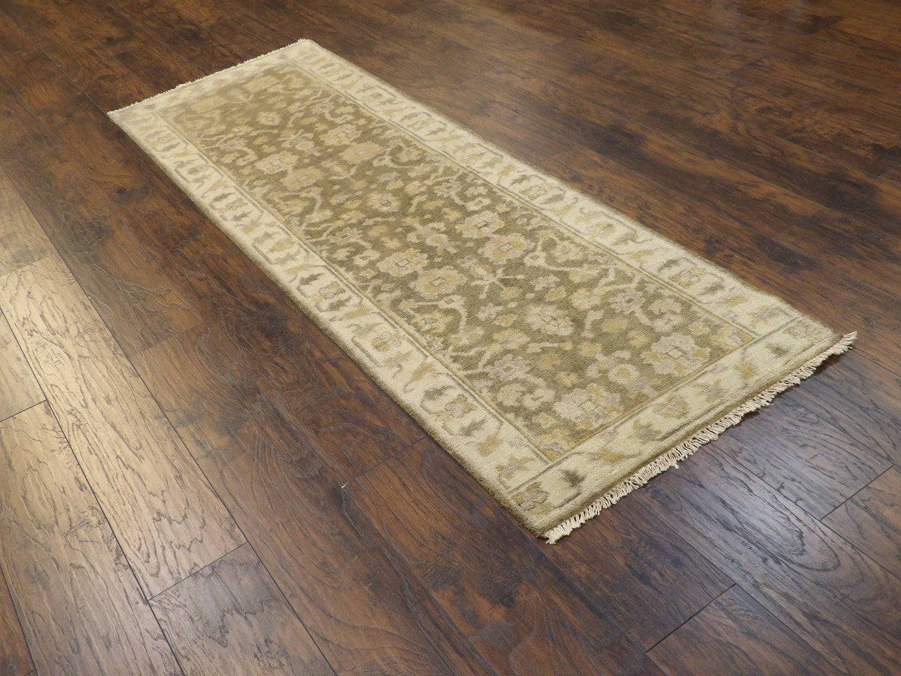 Green Oushak runner in a hallway setting