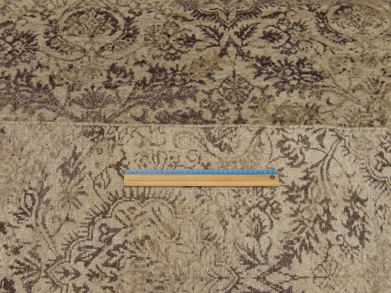 Gray and purple damask rug in room setting