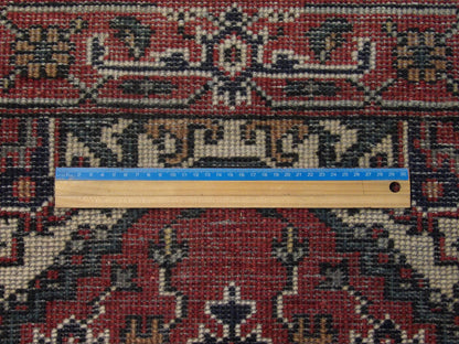Full view of red Tribal Persian Heriz hand-knotted rug