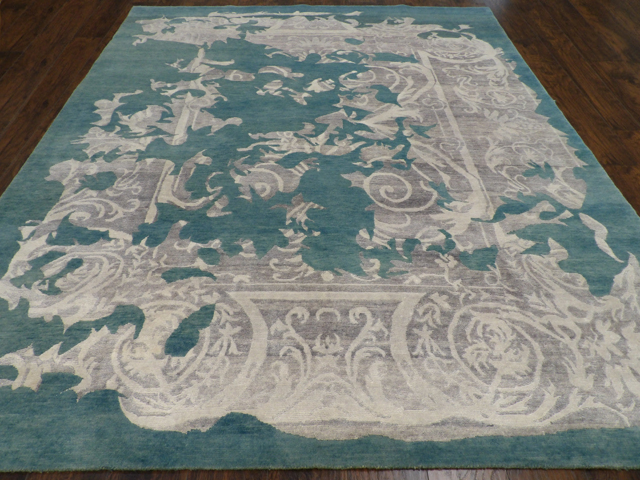 Close-up of wool-silk pile, gray and teal rug