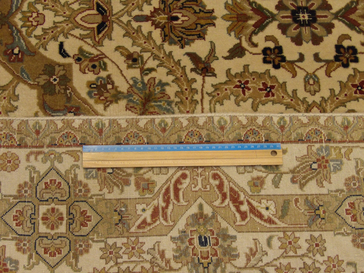 Beige Fine Persian Haji Jalili rug in room setting