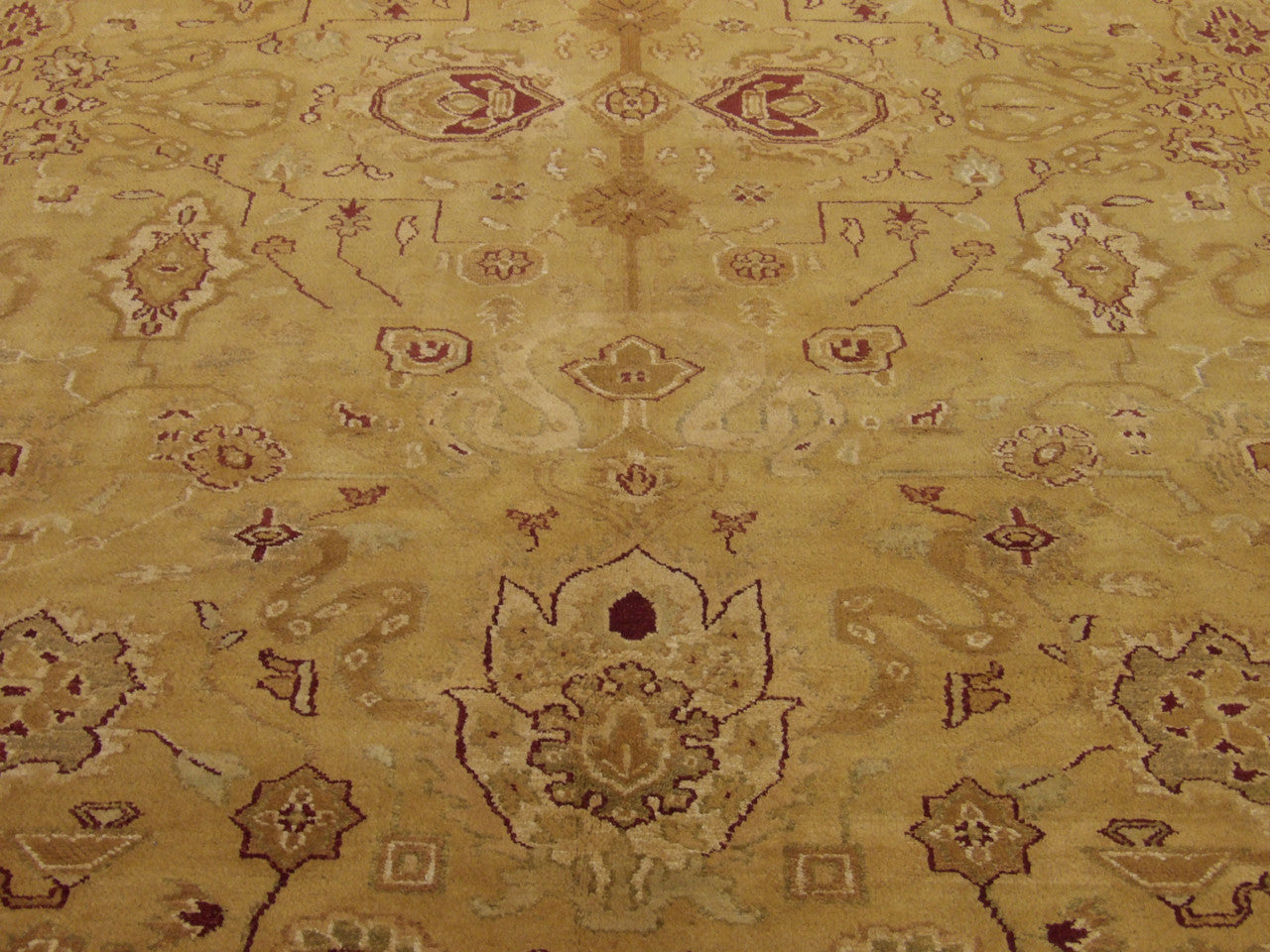 Close-up of wool pile, gold and pink rug