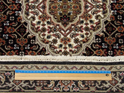 Black Tabriz runner in hallway setting