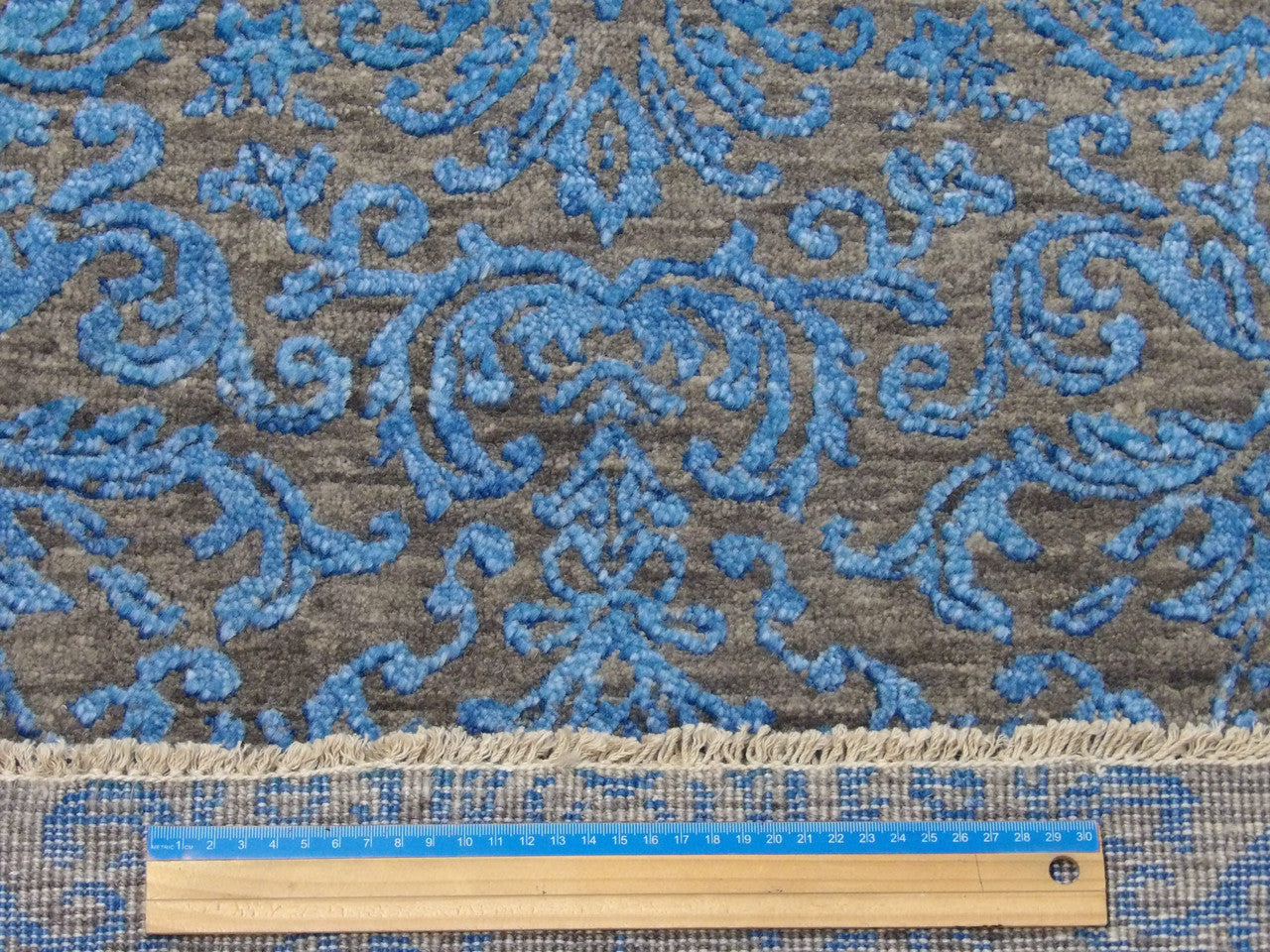 Blue and gray damask runner in hallway setting