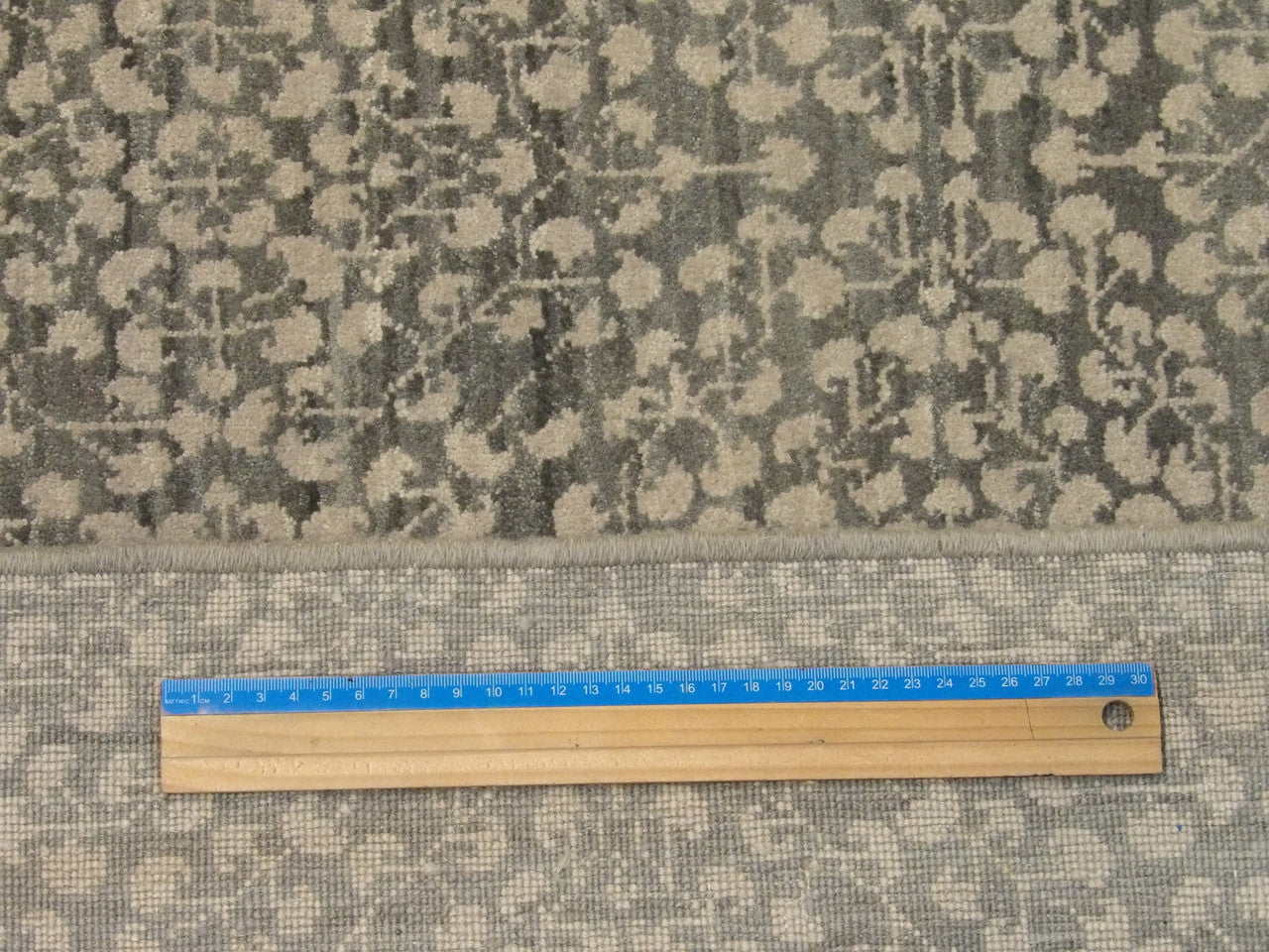 Green floral rug in room setting