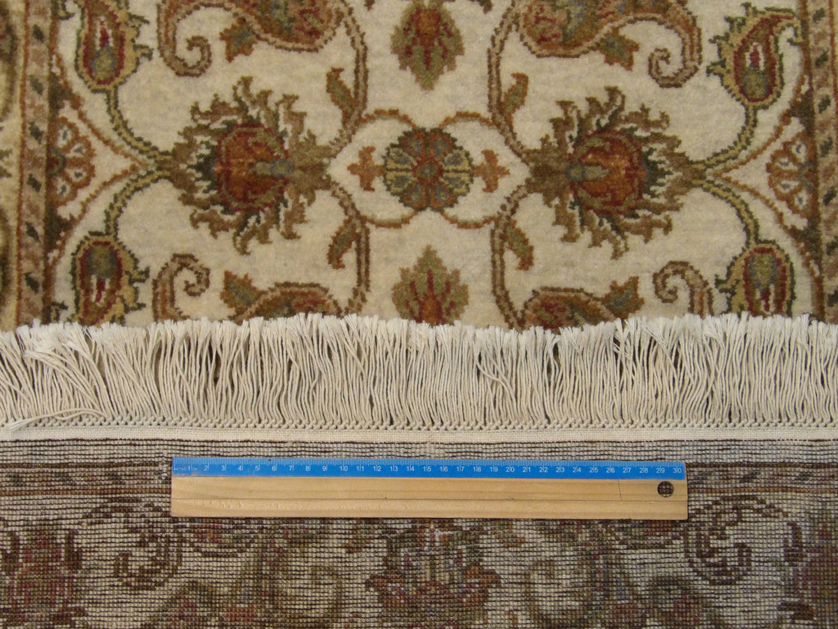 Gold and ivory Kashan runner in hallway setting