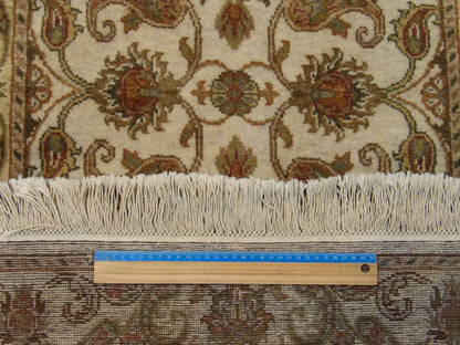 Gold and ivory Kashan runner in hallway setting