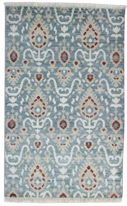 Indo Ikat hand-knotted wool rug in blue and red, full view