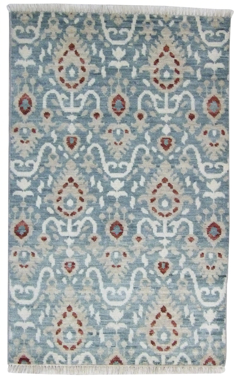 Indo Ikat hand-knotted wool rug in blue and red, full view