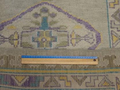 Gray & Purple Anatolian Vintage Oushak rug in room setting