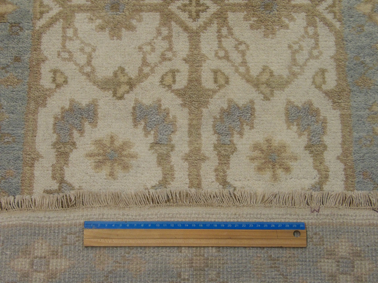 Blue and ivory Oushak runner in hallway setting