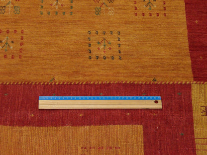 Gold & Red Gabbeh rug in room setting