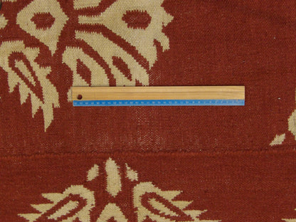 Beige and red coastal rug in room setting