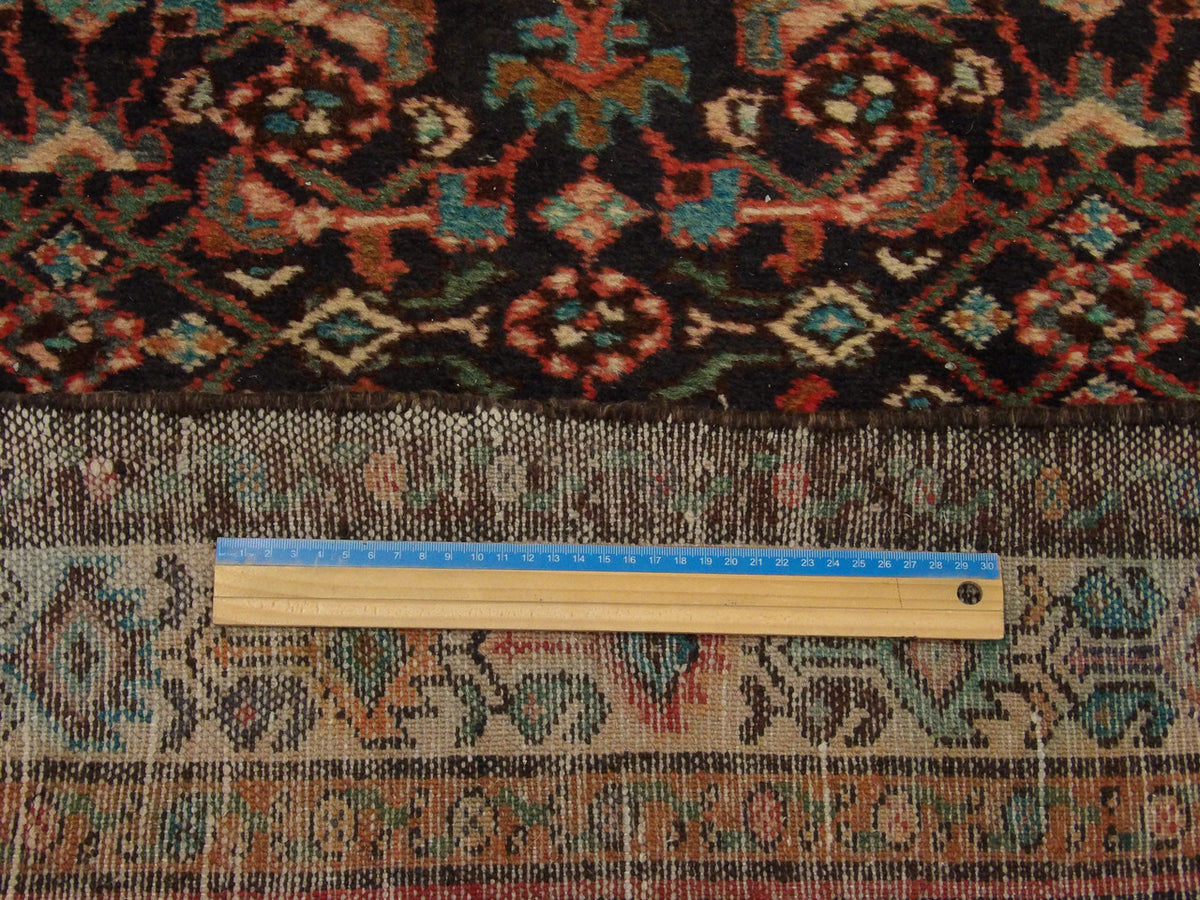Beige & Purple Antique Persian Hamadan rug in room setting