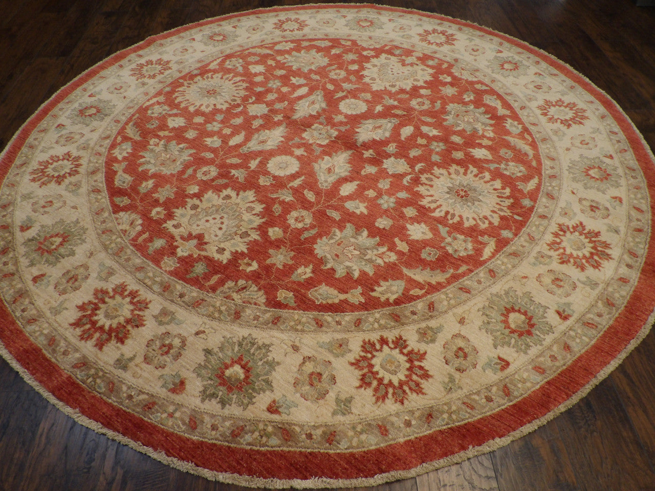Close-up of wool pile, beige and red round rug