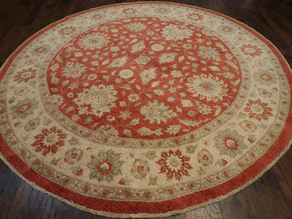 Close-up of wool pile, beige and red round rug