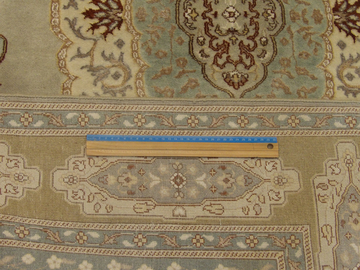 Blue & Gold Fine Persian Haji Jalili Tabriz rug in room setting