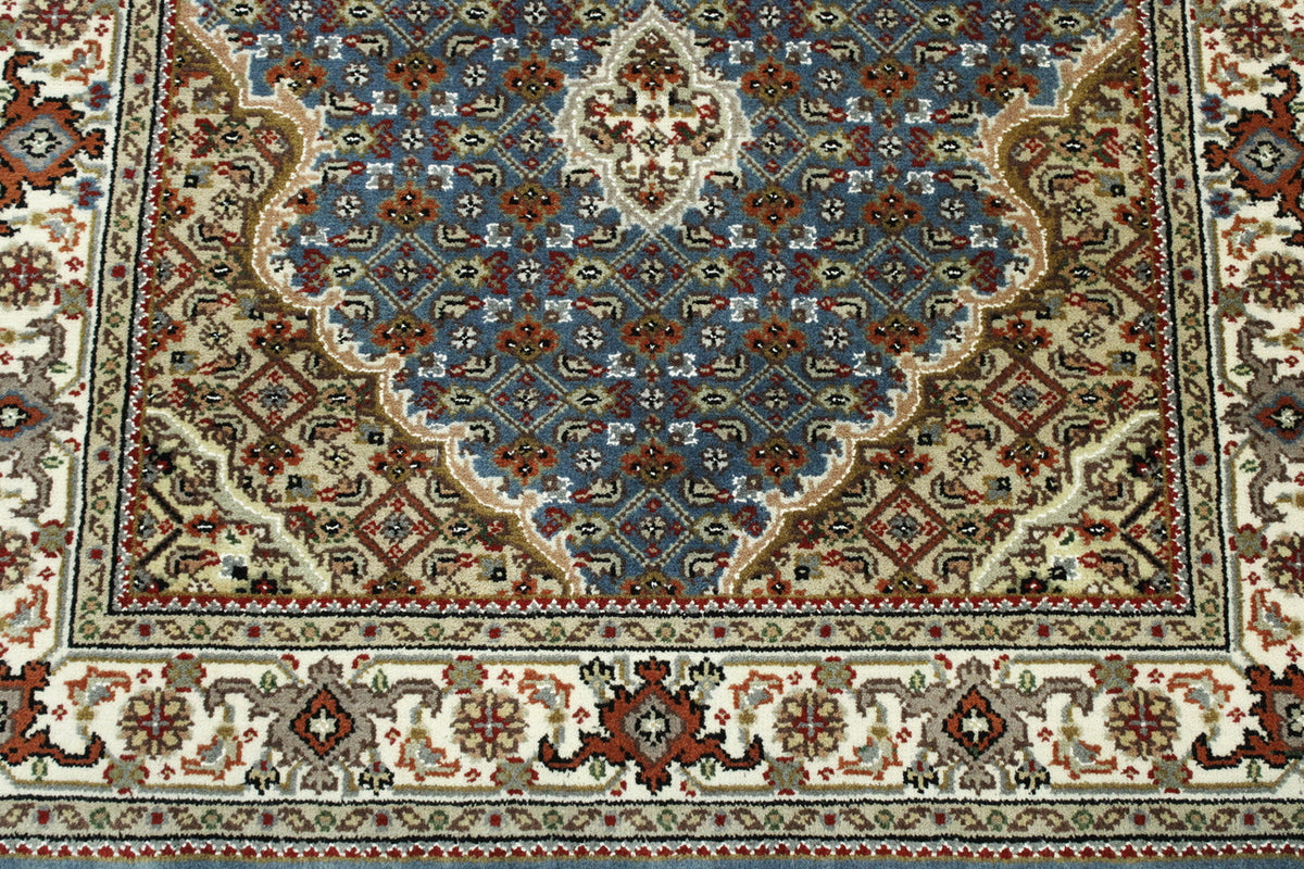 Traditional Tabriz rug border detail