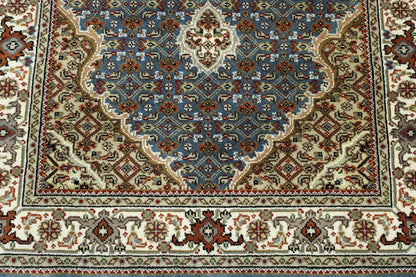 Traditional Tabriz rug border detail