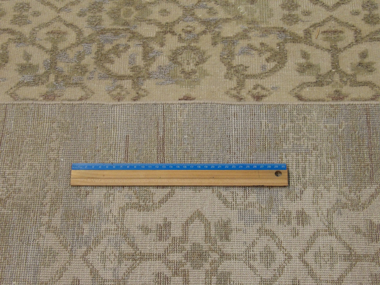 Gold and green Oushak rug in room setting