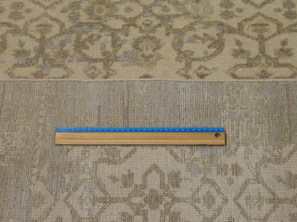 Gold and green Oushak rug in room setting