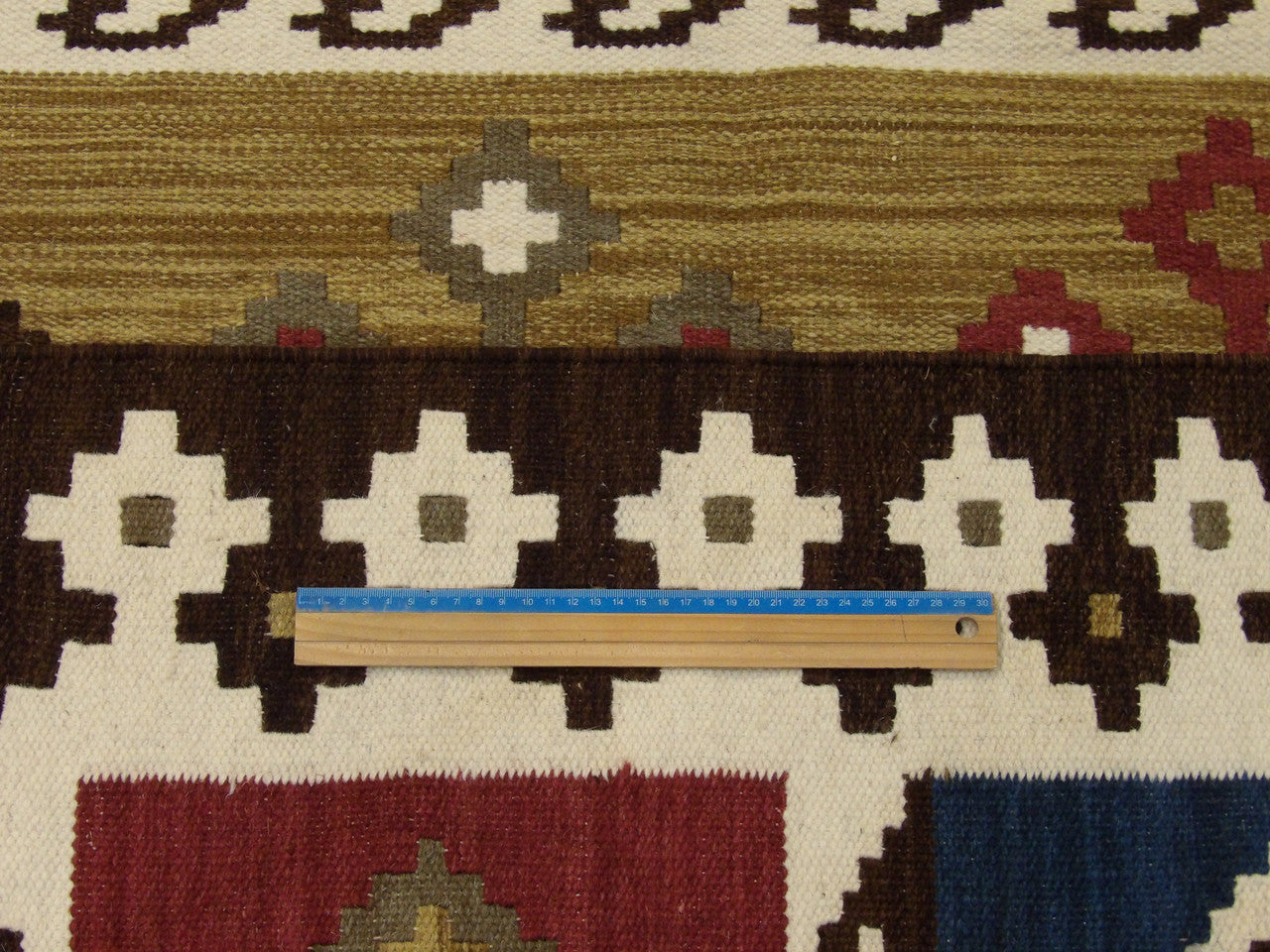 Full room view of multi-color coastal flat weave hand-knotted rug