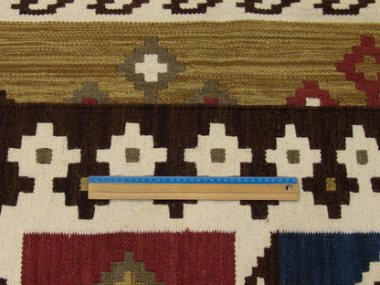 Full room view of multi-color coastal flat weave hand-knotted rug