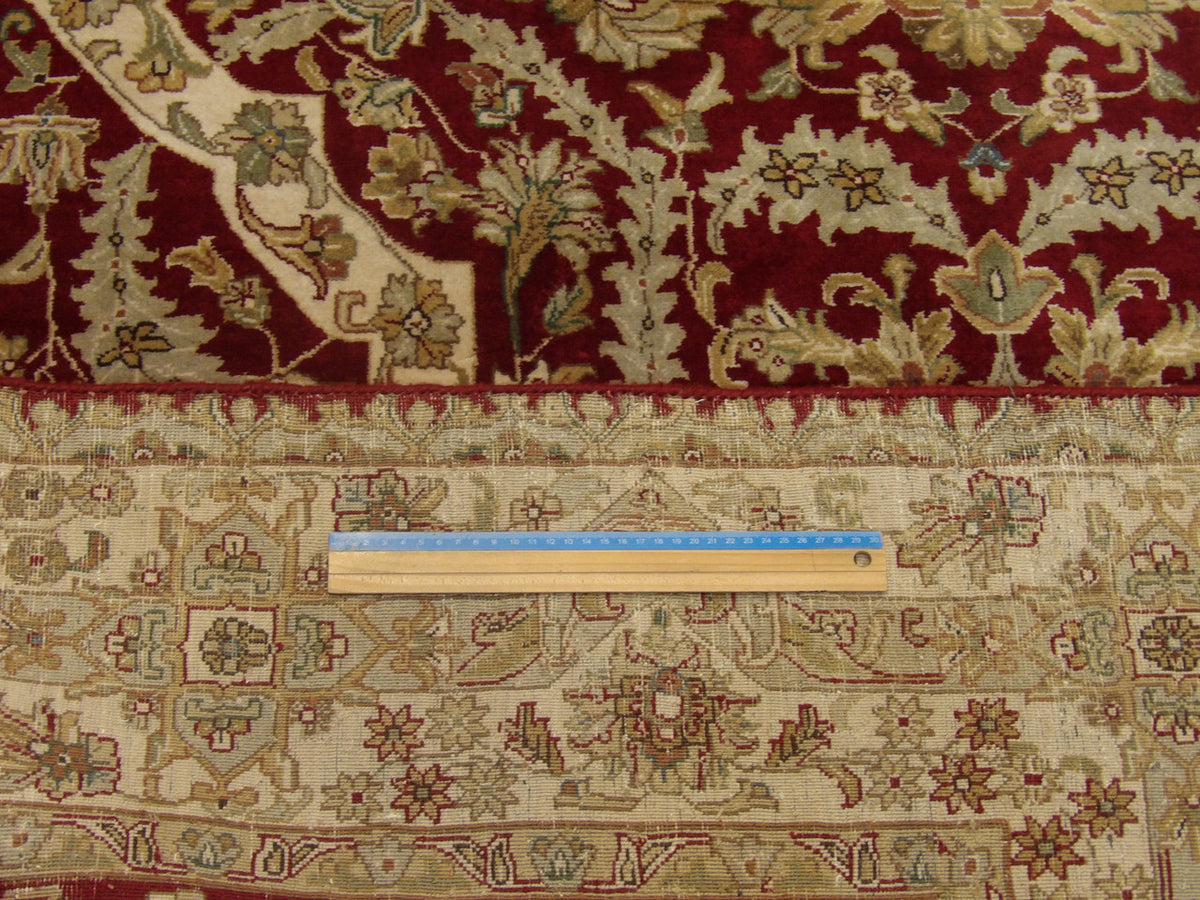 Beige & Red Fine Persian Haji Jalili rug in room setting
