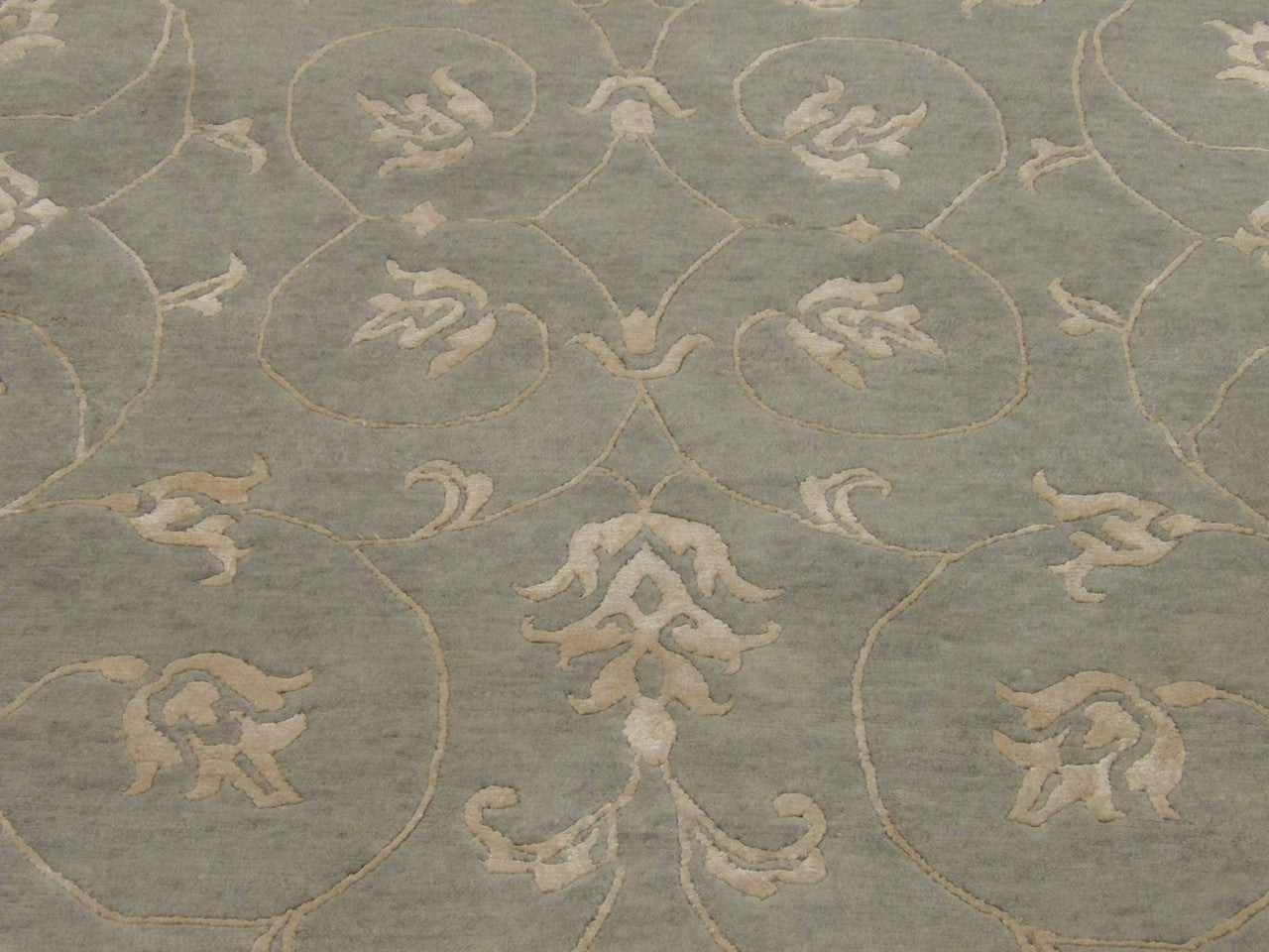 Wool-silk texture close-up, blue and gold leaves rug