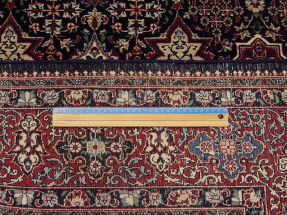 Blue and red Haji Jalili rug in room setting